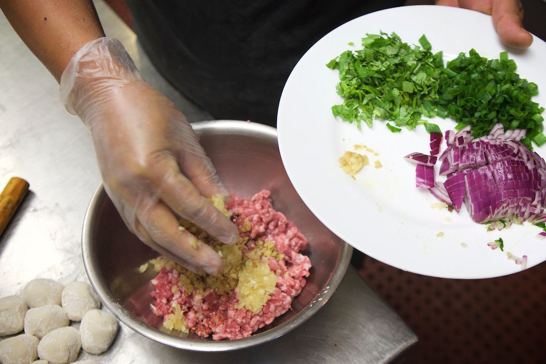 Fresh ingredients like garlic, ginger and red onion are added to the raw filling<br>